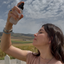 Kate misting her face with Katari Roseau rose water above the hills
