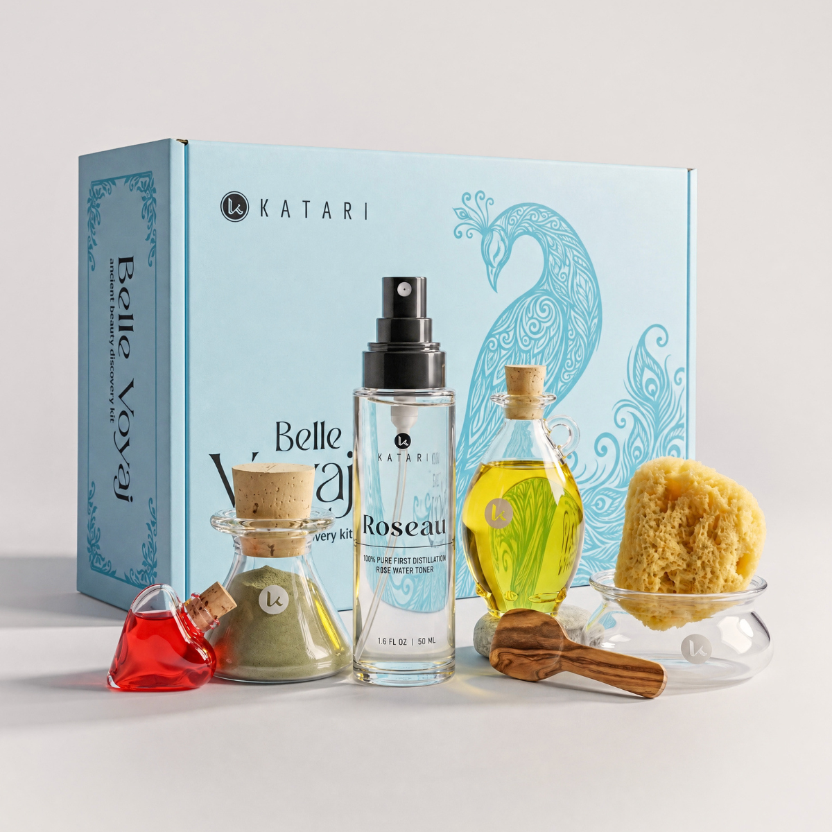 Katari Belle Voyaj ancient beauty discovery kit: peacock gift box with Roseau rose water, oil, green clay, perfume, sea sponge, glass bowl and olivewood spatula
