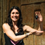 Katari founder Kate holding Katari black seed oil in King Tut's tomb, where black seed oil was found