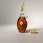 Dropper of Katari cold-pressed black seed oil over a hand-blown glass amphora with its cork