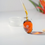 Katari black seed oil pouring from a dropper into a hand-blown glass amphora