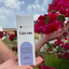 Katari Geran Mediterranean geranium skin hydrator box held up against bougainvillea