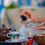 Hand spraying Katari Geran geranium mist beside Tunisian mint tea and a blue painted cup