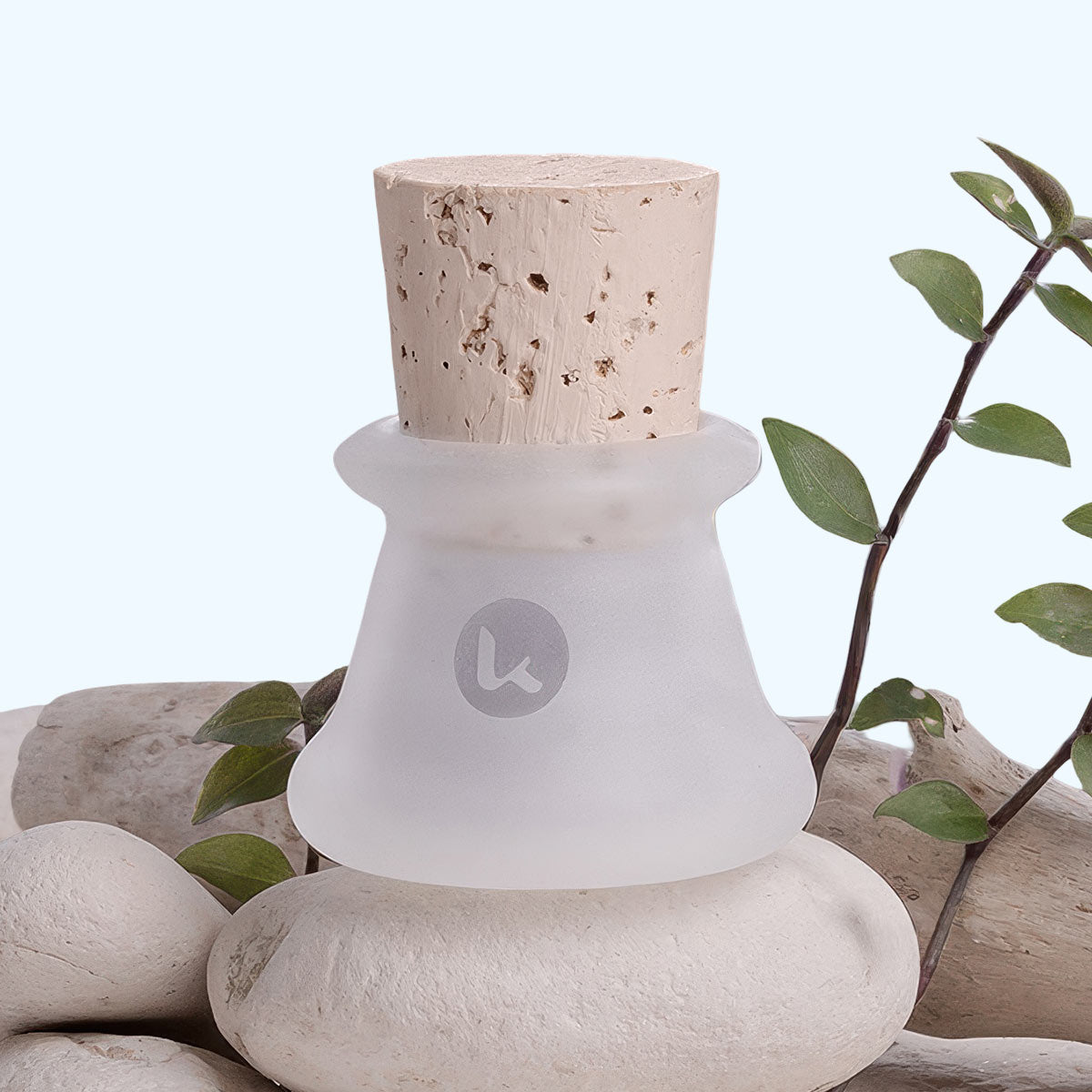 Frosted glass jar with cork stopper on a natural stone surface with green leaves - 0.5 oz