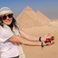 Katari founder Kate holding Katari oils in hand-blown glass at the pyramids of Giza
