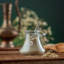 Katari Poudre de Barie prickly pear exfoliating powder in a hand-blown glass jar with a glass spoon and olivewood scoop