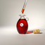 Dropper of Katari Rubi cold-pressed rosehip oil over a hand-blown glass amphora with its cork