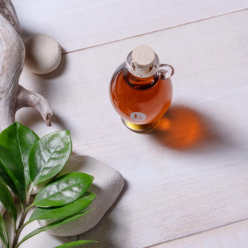 Pure, cold-pressed black seed oil in a hand-blown glass amphora - top view