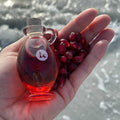 Pomegranate seed oil and pomegranate seeds in the hand