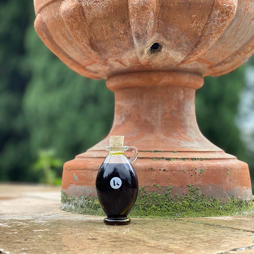 Henna oil in a hand-blown glass amphora