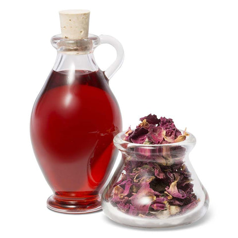 Rosehip oil in a glass amphora and rosehip petals